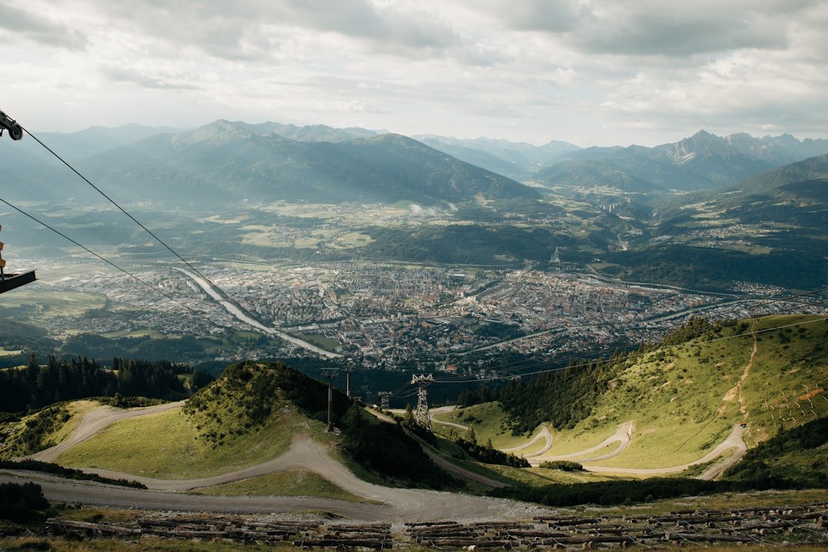 Alpenzoo Innsbruck – City in a valley surrounded by mountains and green slopes