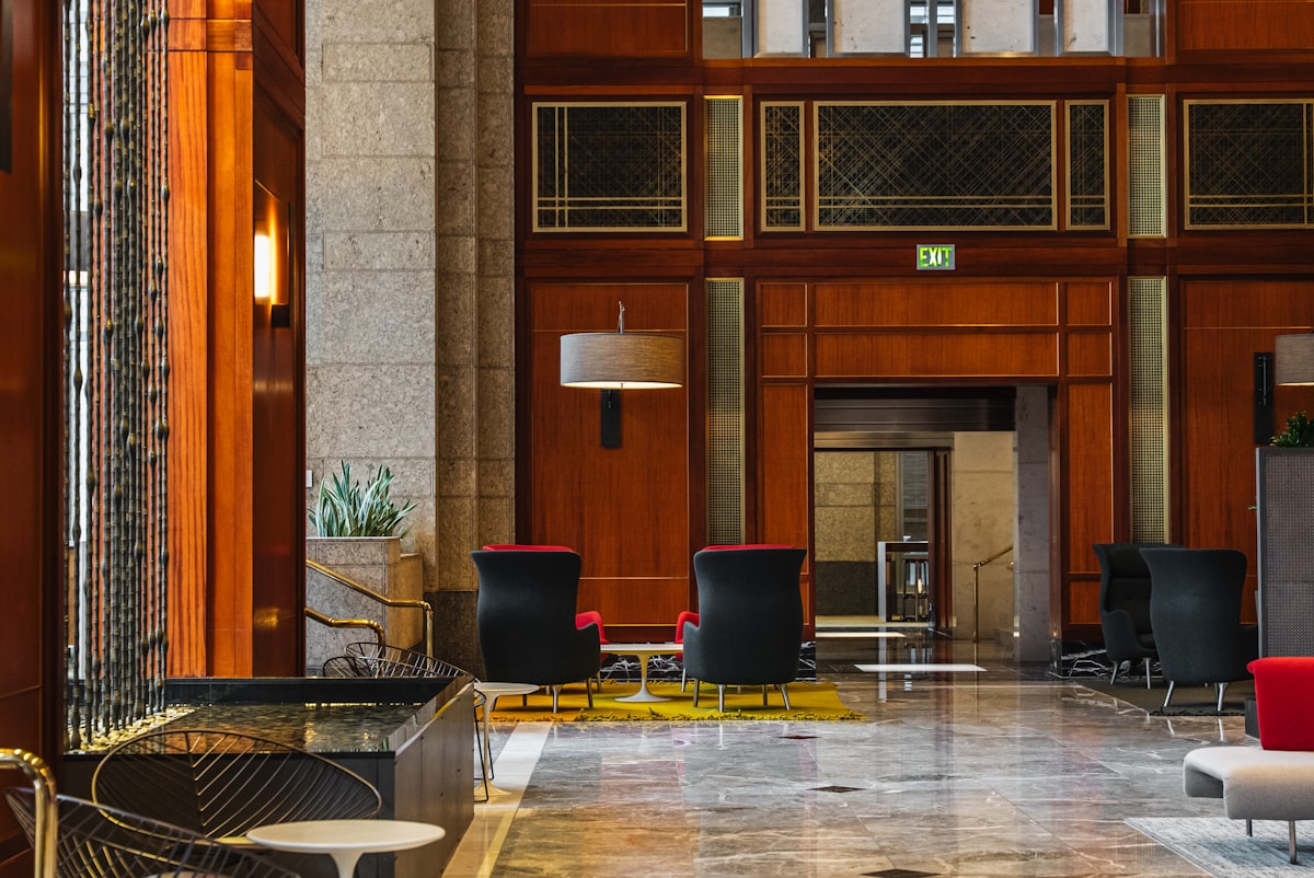 Grand Hotel Europa Innsbruck – Elegant hotel lobby with modern seating and wood paneling
