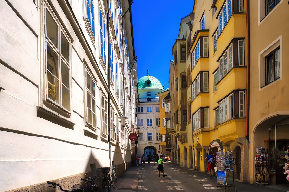 Hofburg Innsbruck – Narrow european street with colorful buildings and a green dome