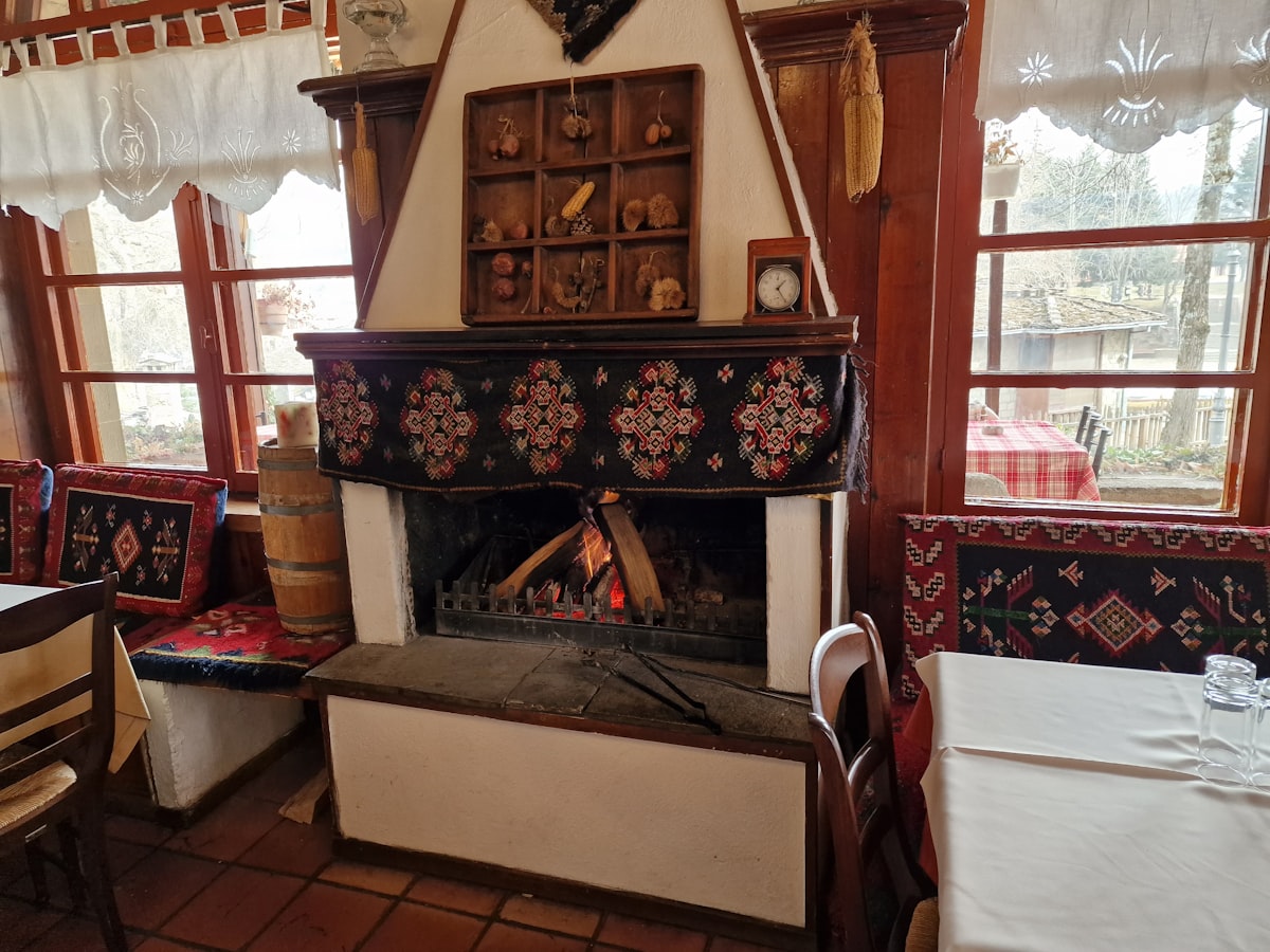 Ottoburg – A fire place in a restaurant with tables and chairs