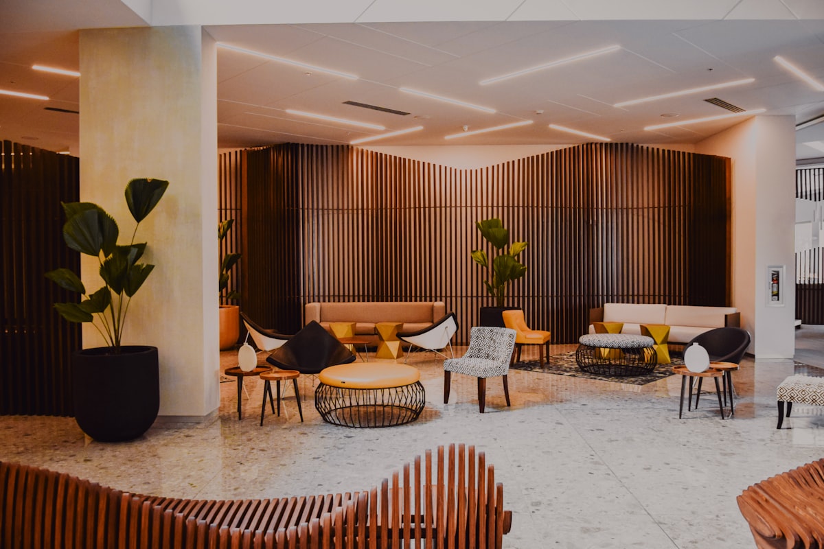 The Penz Hotel – Modern hotel lobby with designer furniture and wood walls