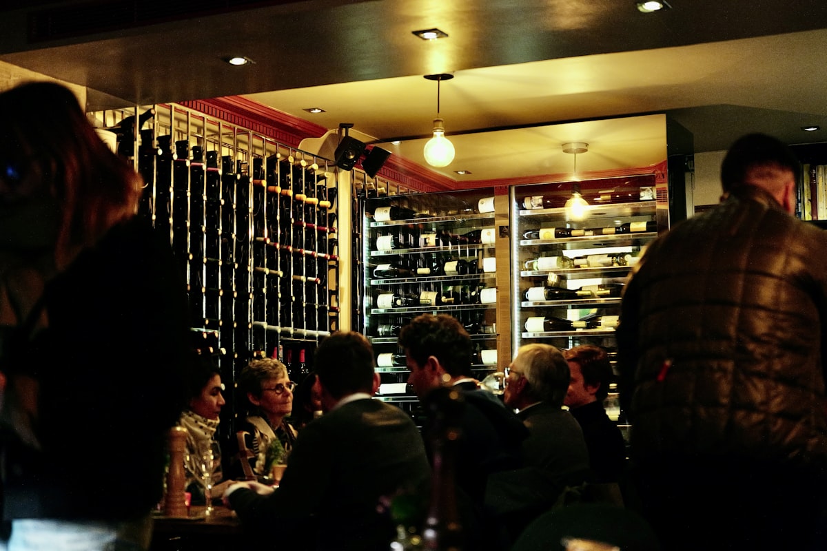 Weinhaus Happ – People dining in a restaurant with wine racks